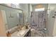 Nautical-themed bathroom with a gray vanity, decorative mirror, and a tub with a themed shower curtain at 2169 Rush Bay Way, Orlando, FL 32824