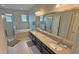 Bright bathroom features a double sink vanity, soaking tub, and a separate glass-enclosed shower at 2169 Rush Bay Way, Orlando, FL 32824
