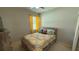 Cozy bedroom with neutral walls, stylish bedding, and a window with bright yellow curtains at 2169 Rush Bay Way, Orlando, FL 32824