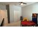 Bedroom with an arcade game and a TV on display, offering a fun and recreational space at 2169 Rush Bay Way, Orlando, FL 32824