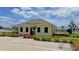Exterior view of community building, featuring landscaped grounds and a black fence surround at 2169 Rush Bay Way, Orlando, FL 32824