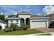 Charming single-story home with a two-car garage, lovely landscaping, and a well-manicured lawn at 2169 Rush Bay Way, Orlando, FL 32824
