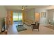 Inviting living room with sliding glass doors to the lanai, neutral decor, and tile flooring at 2169 Rush Bay Way, Orlando, FL 32824