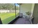 Cozy screened patio with brick flooring, seating and a view of the backyard at 2169 Rush Bay Way, Orlando, FL 32824
