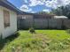 A spacious backyard with a wooden fence offers a private outdoor space at 2250 Maple Hill Dr, Lakeland, FL 33811
