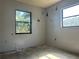 Sunlit bedroom featuring dual windows, awaiting renovation to transform into a cozy and inviting space at 2250 Maple Hill Dr, Lakeland, FL 33811
