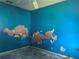 Bedroom with vibrant blue walls, ceiling fan; offering a canvas for creative design and comfort with renovation at 2250 Maple Hill Dr, Lakeland, FL 33811