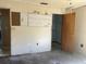 Bedroom with closet, pegboard wall; offering potential for personalized organization and style with renovation at 2250 Maple Hill Dr, Lakeland, FL 33811