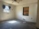 Bedroom with ceiling fan and natural light; awaiting personal touch and renovation to restore its charm at 2250 Maple Hill Dr, Lakeland, FL 33811