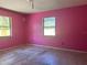 Bedroom with pink walls and two windows, in need of renovation at 2250 Maple Hill Dr, Lakeland, FL 33811