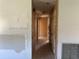 Hallway with outdated decor showing signs of wear and tear with wall damage at 2250 Maple Hill Dr, Lakeland, FL 33811