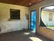 Enclosed patio needing repair with a damaged wall, wood ceiling, and boarded-up window at 2250 Maple Hill Dr, Lakeland, FL 33811
