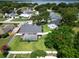 Aerial view of a home featuring a sparkling pool, screened-in lanai, and mature landscaping at 2264 Palmview E Cir, Auburndale, FL 33823