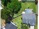 Birds eye view of a home showcasing a pool, backyard, trees, and the roof at 2264 Palmview E Cir, Auburndale, FL 33823