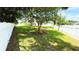 Spacious backyard featuring a lush green lawn, mature trees, and a pristine white fence at 2264 Palmview E Cir, Auburndale, FL 33823