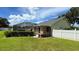 Well-maintained backyard featuring a cozy screened-in porch and a white privacy fence at 2264 Palmview E Cir, Auburndale, FL 33823