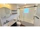 Stylish bathroom featuring subway tile, dark fixtures, glass shower door, and wood shelving at 2264 Palmview E Cir, Auburndale, FL 33823