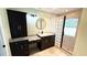 Bathroom featuring granite counters, dark cabinets, and glass block shower at 2264 Palmview E Cir, Auburndale, FL 33823