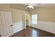 Bedroom with wood floors and door to the closet at 2264 Palmview E Cir, Auburndale, FL 33823