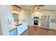 Bright kitchen featuring white cabinets, stainless steel appliances, and wood flooring, blending style and functionality at 2264 Palmview E Cir, Auburndale, FL 33823