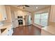 Well-lit kitchen with stainless steel appliances, white cabinetry, and dark wood floors, offering modern convenience at 2264 Palmview E Cir, Auburndale, FL 33823