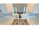 Close-up of a modern kitchen sink with marble countertops and views of the pool and backyard at 2264 Palmview E Cir, Auburndale, FL 33823