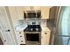 Close up of a kitchen featuring modern stainless steel appliances, white cabinetry, and stylish countertops at 2264 Palmview E Cir, Auburndale, FL 33823