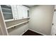 Well-equipped laundry room with stylish cabinets, shelving, and sleek wood-look flooring at 2264 Palmview E Cir, Auburndale, FL 33823