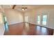 Inviting living room with wood floors and french doors leading to the pool area at 2264 Palmview E Cir, Auburndale, FL 33823