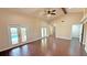 Spacious living room features vaulted ceiling, ceiling fan, and gleaming wood floors at 2264 Palmview E Cir, Auburndale, FL 33823