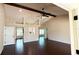 Open-concept living room with vaulted ceilings, a ceiling fan, wood beam, and dark hardwood floors at 2264 Palmview E Cir, Auburndale, FL 33823