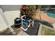 Pool equipment area with filtration system and blooming plants nearby at 2264 Palmview E Cir, Auburndale, FL 33823