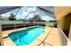 Beautiful screened-in pool surrounded by well-manicured landscaping and a sunny patio at 2264 Palmview E Cir, Auburndale, FL 33823