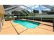 Sparkling pool inside screen enclosure with ample patio space and mature landscaping at 2264 Palmview E Cir, Auburndale, FL 33823
