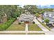 Aerial view of the home showing the roof, landscaping, driveway, and proximity to neighboring houses at 236 E Seminole Ave, Lake Wales, FL 33853