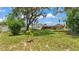 Expansive backyard with a view of the property's screened porch and neighboring houses at 236 E Seminole Ave, Lake Wales, FL 33853