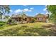 Lush backyard view featuring a screened in porch and well maintained lawn at 236 E Seminole Ave, Lake Wales, FL 33853