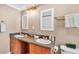 Bathroom featuring dual sinks, granite countertops, light-toned walls, and a neutral decor at 236 E Seminole Ave, Lake Wales, FL 33853