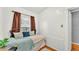 Small bedroom with twin bed, white-paneled walls, hardwood floors and a window at 236 E Seminole Ave, Lake Wales, FL 33853