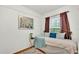 Modest bedroom with twin bed, white paneled walls, hardwood floors, and a window at 236 E Seminole Ave, Lake Wales, FL 33853