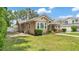 Side view of the home showing the chimney, windows, siding and landscaped yard at 236 E Seminole Ave, Lake Wales, FL 33853