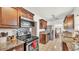 Well-lit kitchen featuring granite countertops, stainless steel appliances and view into dining area at 236 E Seminole Ave, Lake Wales, FL 33853
