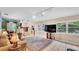 Bright living room with tile flooring, large windows, and stairs to a dining room area at 236 E Seminole Ave, Lake Wales, FL 33853