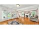 Bright living room with hardwood floors, fireplace, built-in shelving and French doors to the porch at 236 E Seminole Ave, Lake Wales, FL 33853
