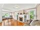 Cozy living room featuring a fireplace, built-in shelving, and hardwood floors with ample natural light at 236 E Seminole Ave, Lake Wales, FL 33853
