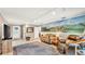 Spacious living room with a mural on the wall, comfortable seating, and ample natural light at 236 E Seminole Ave, Lake Wales, FL 33853