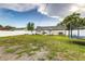Lawn in the backyard with privacy fence, patio set, and trampoline at 2443 Delrose E Dr, Lakeland, FL 33805
