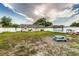 Spacious backyard with play equipment, a picnic table, a grill, and fully fenced with a white vinyl fence at 2443 Delrose E Dr, Lakeland, FL 33805