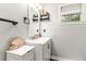 Well-lit bathroom featuring a modern vanity, framed mirror, sleek fixtures and a clean, functional design at 2443 Delrose E Dr, Lakeland, FL 33805