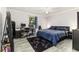 Spacious bedroom featuring plank flooring, a ceiling fan, large windows, and a comfortable layout for relaxation at 2443 Delrose E Dr, Lakeland, FL 33805